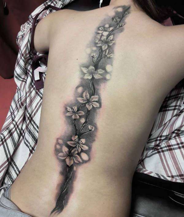 Tatuaje en la columna vertebral: flores de cerezo